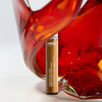 HECH skincare serum bottle with a glass of red wine in the background